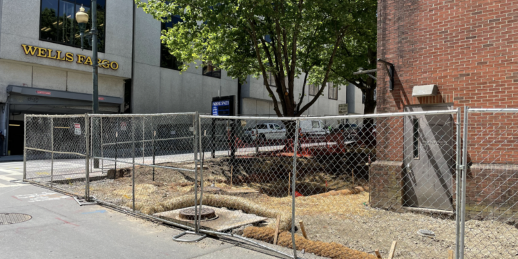chain link fence surrounding work site for new bathroom at College and Rankin