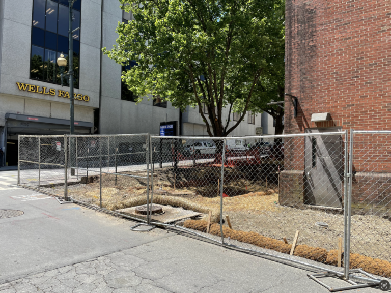 chain link fence surrounding work site for new bathroom at College and Rankin