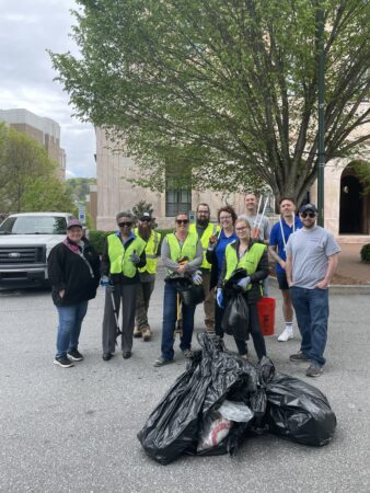 various staff who participated in Spring Litter Sweep in front of City Hall with collected trash