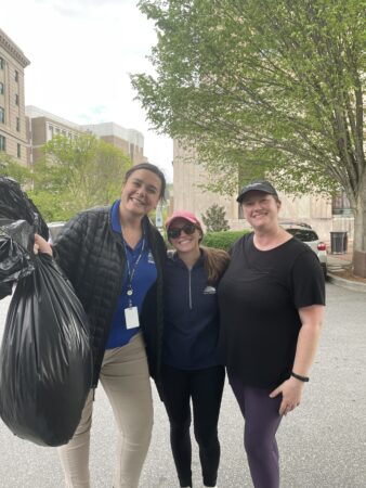 City of Asheville staff with bag of collected litter