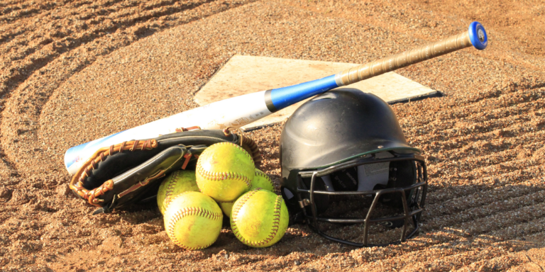 yellow baseballs, batting helmet and baseball bat laying on field