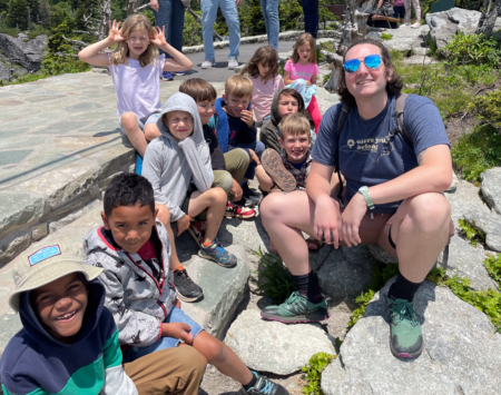 kids posing with summer camp leader