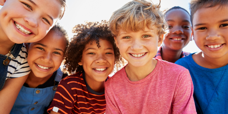 group of young children looking down at camera