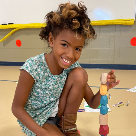 young african american girl stacking blocks