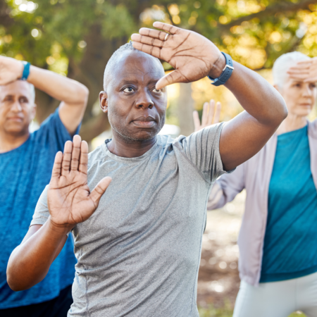 african american man in tai chi pose with outward facing palms at face level