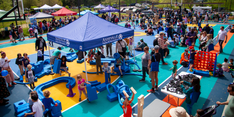 event with tents and families, kids browsing