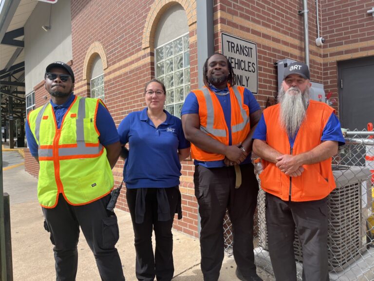 art drivers standing together with safety vests on