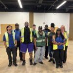 art drivers standing together with safety vests on