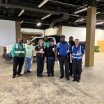 art drivers standing together with safety vests on