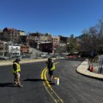 crews working to restripe the street for reopening on a blue sky day
