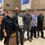 ART STAFF STANDING WITH COUNCIL MEMBER RECIEVING PROclamation