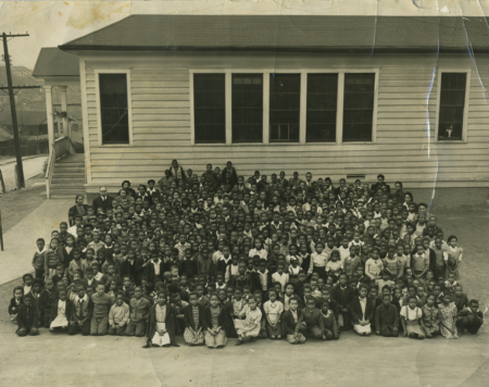 large group of african american children in front of school building