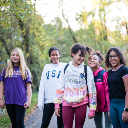 group of young girls walking on greenway
