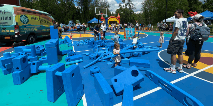 many blue foam blocks on basketball court beside rec and roll van