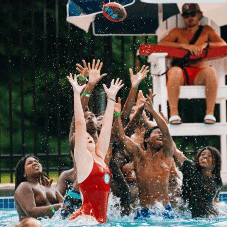 youth playing with a water football in the pool