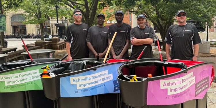 People with cleaning carts in downtown Asheville