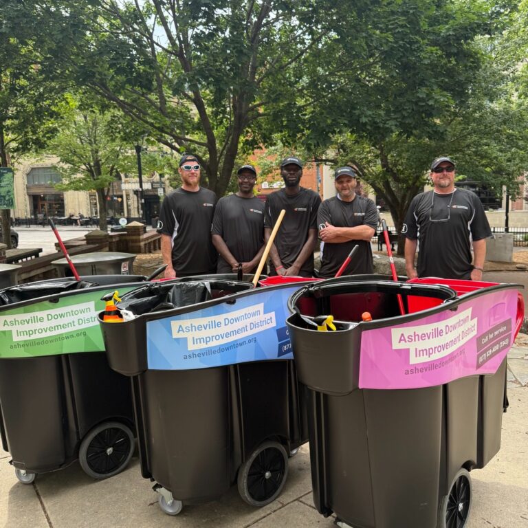People with cleaning carts in downtown Asheville