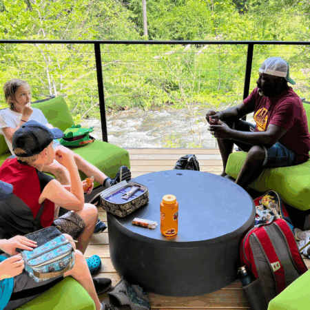 D. Tyrell McGirt sits around table with 3 young children