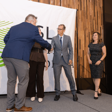 Pete Wall shakes hand and receives award