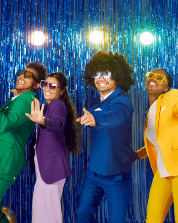 four people in green purple blue and yellow at a dance