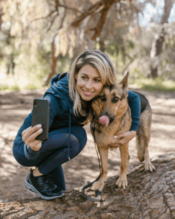 woman taking selfie with german shepherd dog