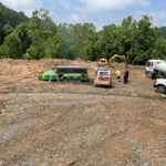 the charboss machine on site with a trackhoe nearby