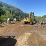 A trackhoe moves debris for the biochar pilot program