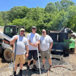 three staff members operate the charboss on site