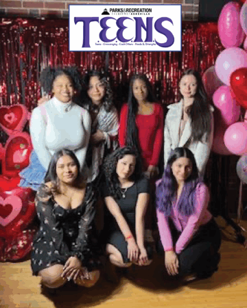 young women in front of banner that says 'Asheville Parks & Recreation Teens'