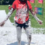 Anice Smith wearing red shirt and black shorts covered in white foam