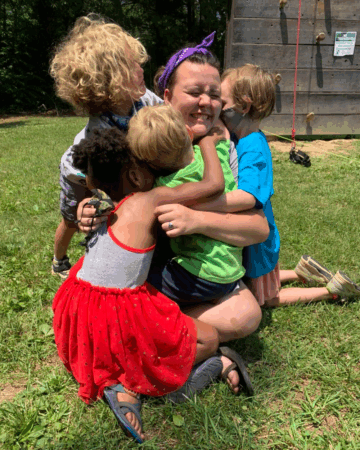 Fallon Hyders gets a group hug from small children