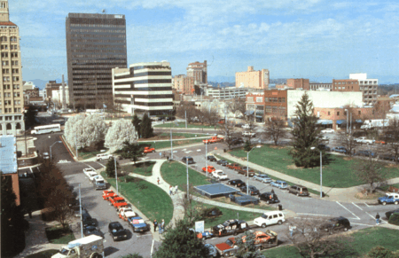 One of the final years of City-Council Plaza and Pack Square shows a space made for vehicles with green space serving a secondary function. The stage near the center was set up for Shindig on the Green. A diagonal street cut through the middle section of the current park creating an isolated triangular island between College, Spruce, and South Market streets that was long home to Energy Loop, the city’s first piece of public art.