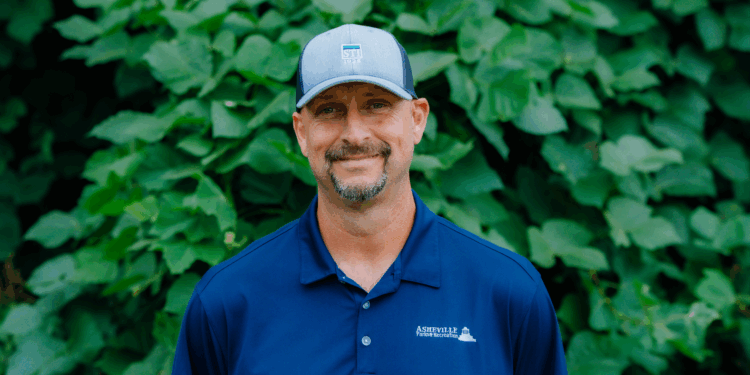 Dwayne Walker wearing blue Asheville Parks & recreation polo shirt