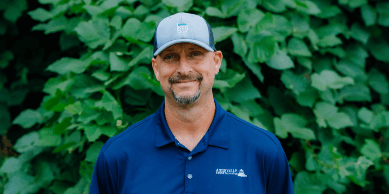 Dwayne Walker wearing blue Asheville Parks & recreation polo shirt