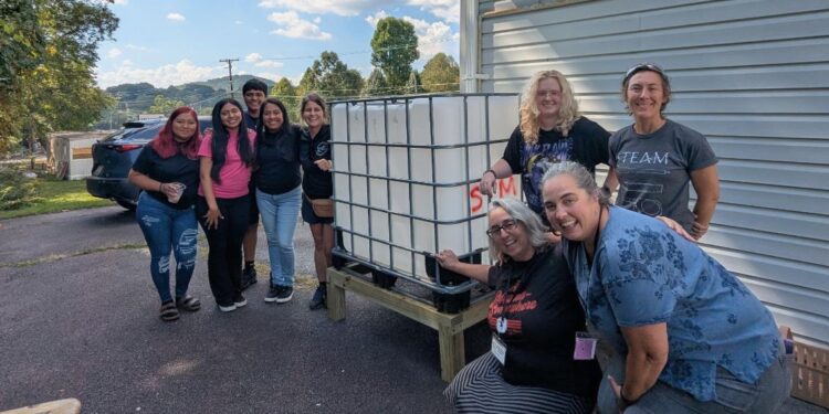 Dulce Mirian Porras works with community partners at Swannanoa Communities Together on a water capturing and filtration system.
