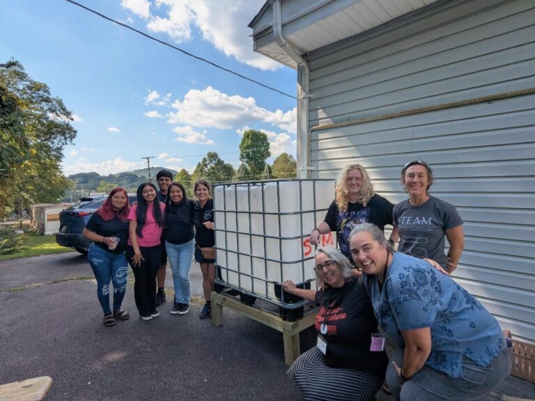 Dulce Mirian Porras works with community partners at Swannanoa Communities Together on a water capturing and filtration system.