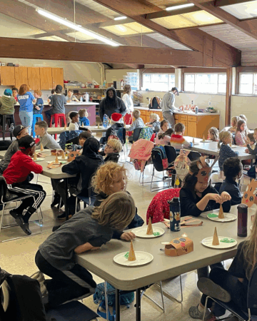 groups of children sitting at table involved in activities