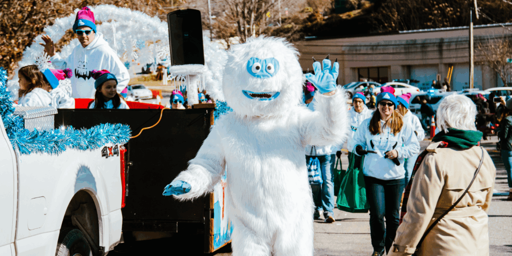 abominable snowman in costume walks in holiday parade