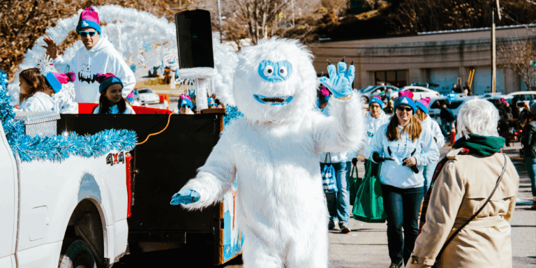 abominable snowman in costume walks in holiday parade