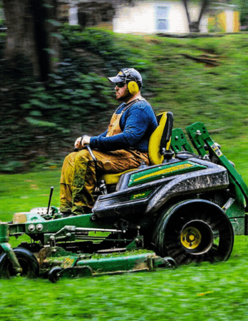 Parks and Recreation employee drives a commercial grade mower