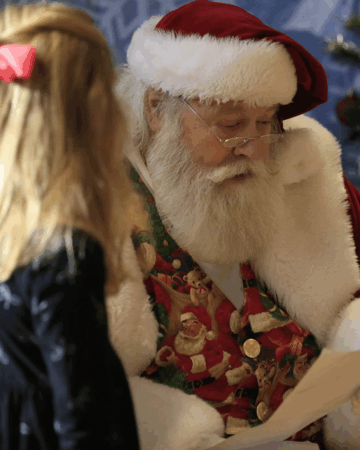 santa talks with young girl with long blond hair