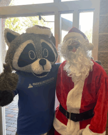 santa in costume with parks and recreation raccoon mascot 