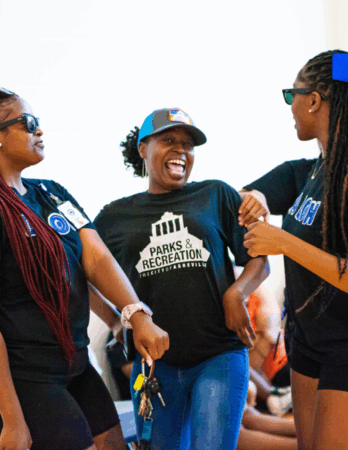 Christin King smiles while talking with a group of teenagers