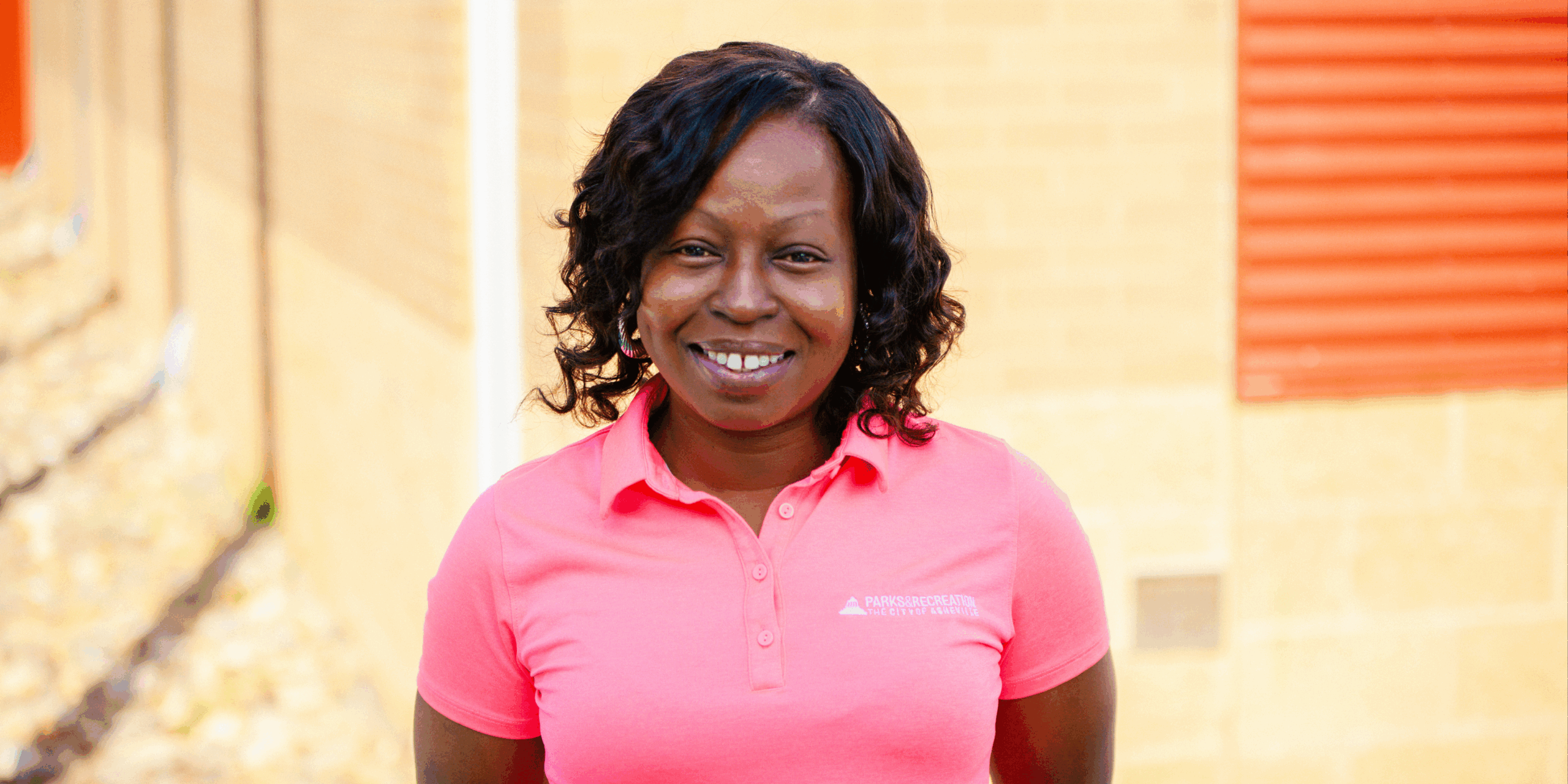 Christin King wears pink Asheville Parks & Recreation shirt