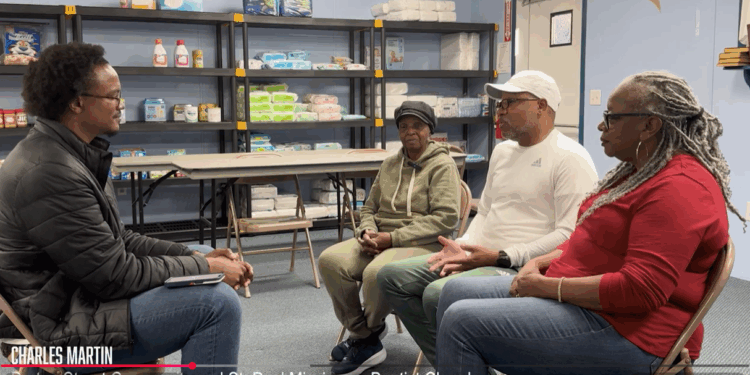 Trey Irby speaks to members of the Burton Street Community about their Helene experience