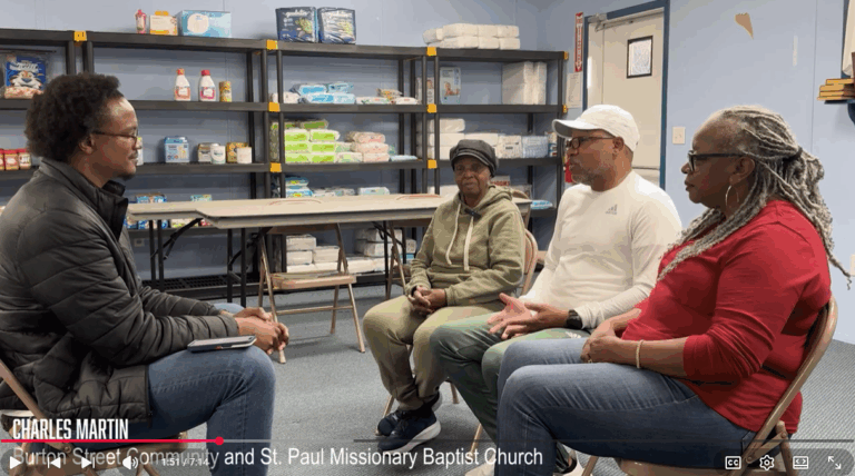 Trey Irby speaks to members of the Burton Street Community about their Helene experience