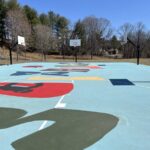 blue basketball court with colorful shapes at Walton Street Park