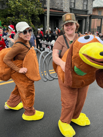 Tracy Wyman and co-worker wear turkey costumes in holiday parade