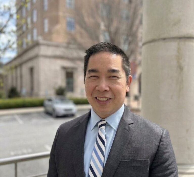 walter ear stands in front of Asheville City Hall