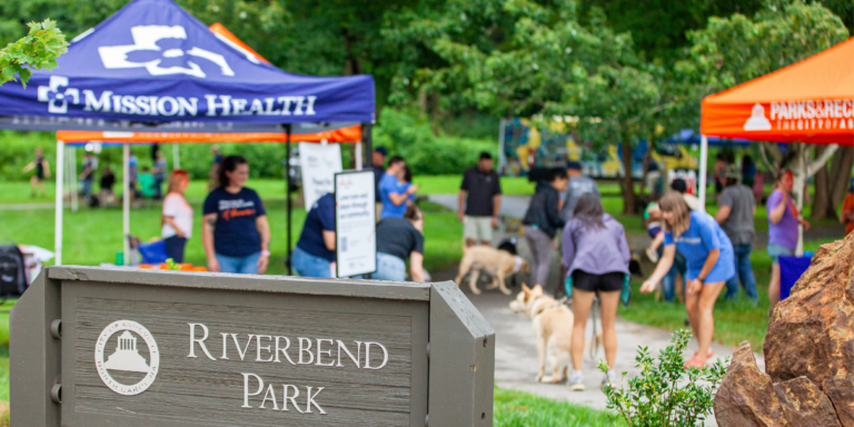 entrance to riverbend park with pop up tents in the background